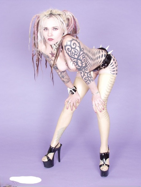 Tattooed blonde Voltaire Blue models naked in a spiky belt and heels 68894192