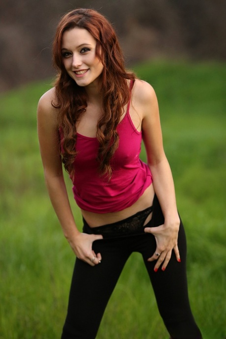 Redhead amateur Hayden Ryan slides legging over thong atop fallen tree 65058712