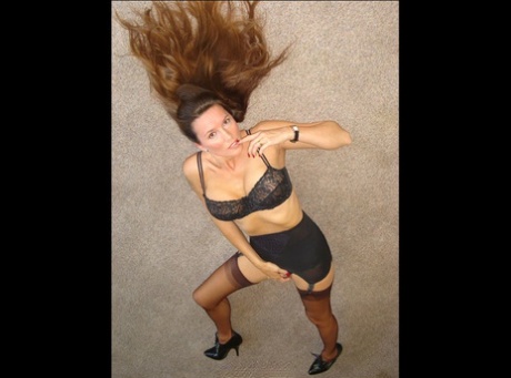 Mature model Nylon Jane lays on carpet flooring in three piece lingerie 60339297
