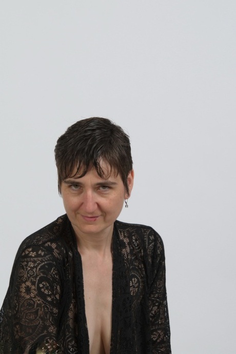 Older model Hot MILF slowly frees herself of black lingerie to pose nude