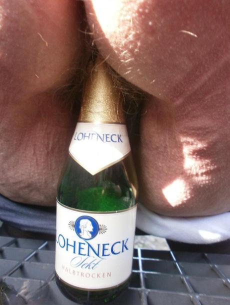 Horny old Caro outdoors in boots spreading pussy to toy with wine bottle 55107921