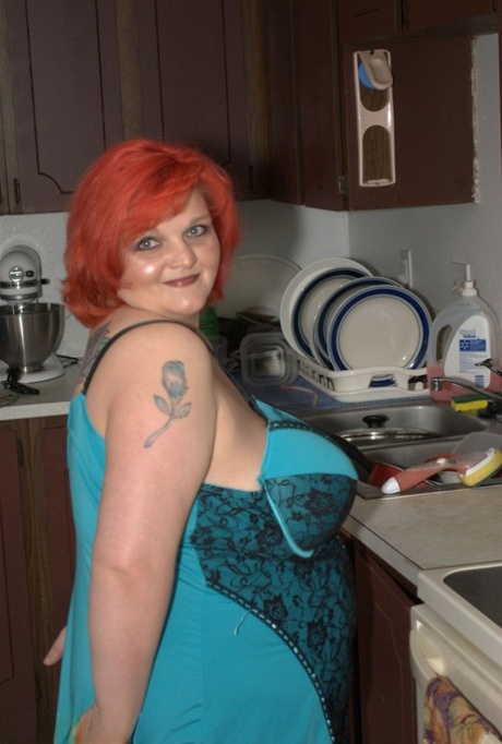 Overweight redhead Black Widow AK plays with her big tits while in her kitchen 55516474