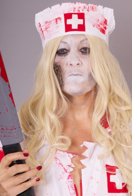 Old blonde amateur Savana removes a nurse uniform during a cosplay scene