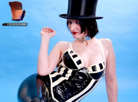 Sexy MILF sports a slave collar while modelling latex clothing and a top hat 84872931
