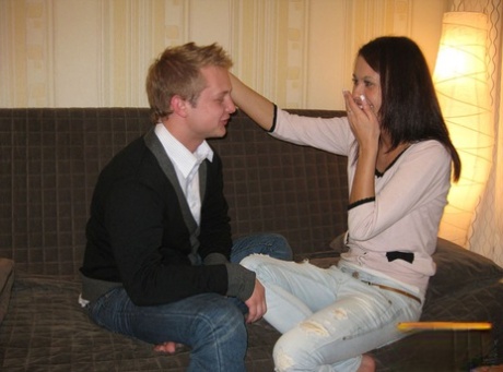 Young lovers kiss before undressing for unprotected sex on a futon 89576315