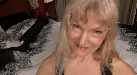 Blonde granny Cindy masturbates with a vibrator on her bed in the nude 53780201