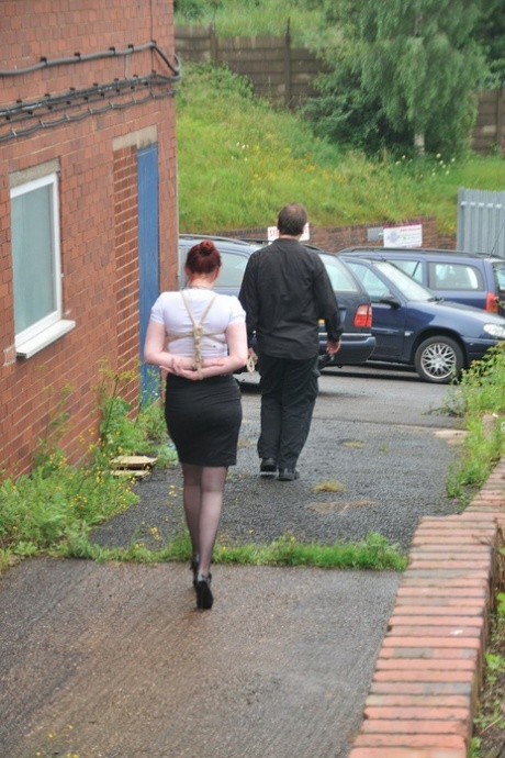 Redhead licks her Master's boots in parking lot before crawling on all fours 86813147