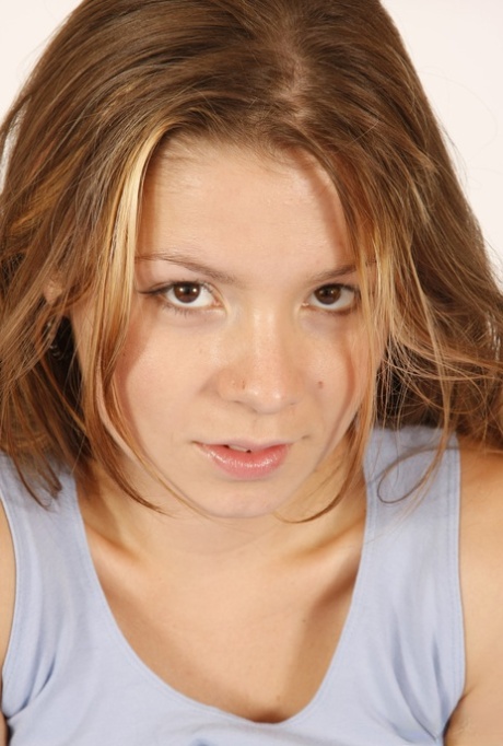 Barely legal girl with long hair goes topless in a teasing manner on a bed 21622352