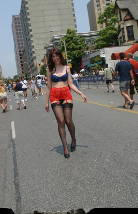 Amateur girl strolls down a city street in her underthings and nylons 42915169