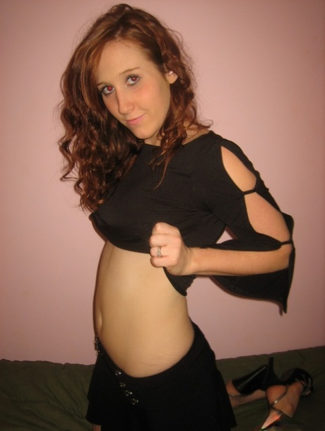 Young girl with curly red hair goes topless before masturbating on a bed 63081124