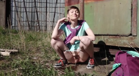 Short haired girl Mariam takes a badly needed pee behind a shed 27704017