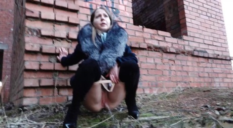 Distressed girl Nastya pulls down her tights to pee by an abandoned building 18994239