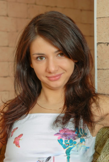 Barely legal cutie Dena takes off all her clothes while alone on a sofa 14295103