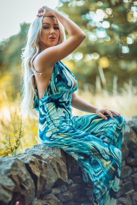 Gorgeous blonde Beth Morgan gets naked against a dry stacked stone wall 19509042