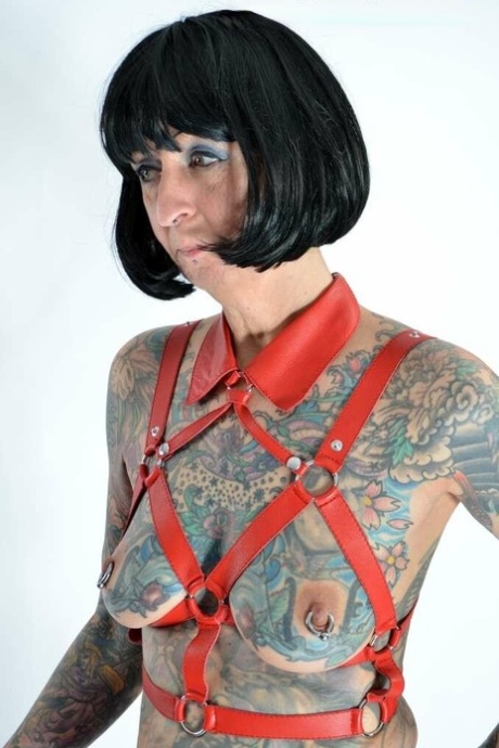 Solo girl Tattoogirl Cleo models a bondage harness in thigh-high boots 73758584