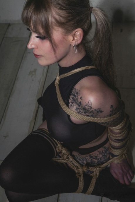 Tattooed blonde Carmine Worx has her arms tied behind her back 90866156