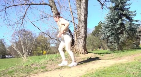 Caucasian chick Lara Fox leans back against a tree while taking a piss 63030409