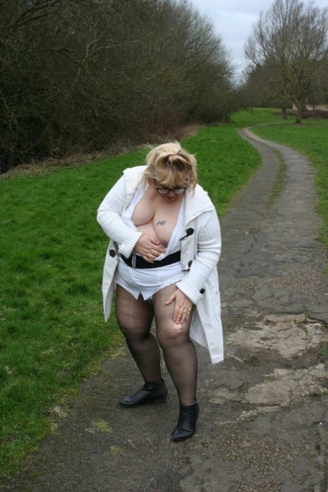 Obese UK blonde Lexie Cummings exposes her breasts on a countryside path