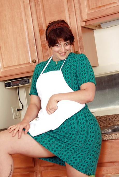Fatty brunette woman with big tits Gwyneth stripping in the kitchen 70400637